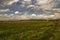 Ararat valley with fields and meadows and with young vineyards and apricot gardens on the background of spring evening sky