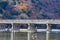 Arashiyama wooden bridge cross over river and autumn season