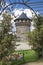 Arbor with flowers and watchtower of the castle ramparts