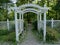 Arbor leading to a shady tree filled park