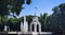 Arbor made of white concrete in the city near the fountain with the flag of Ukraine.