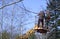 Arborist cutting branches of a tree using truck-mounted lift. Kyiv, Ukraine