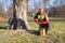 Arborist men standing against two big trees. The worker with helmet working at height on the trees. Lumberjack working with ch