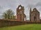 Arbroath Abbey Ruins lie under a Darkening Sky threatening rain on aa early Summers Morning in May.