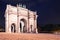 Arc de Triomphe on the Carrousel square near the Louvre museum at night, illuminated by lights and lanterns