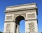 Arc de Triomphe from Champs Elysees with blue sky. Paris, France.