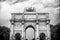 Arc de triomphe du carrousel in paris, france. Arch monument and green trees on cloudy sky. Architectural symbol of