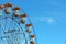 Arc of a ferris wheel against a blue sky