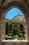 Arc and garden at Saint Just Cathedral cloister at Narbonne in