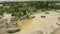 Arc shot of small concrete factory working conveyor and storage towers