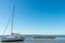 Arcachon Bay, France, sailboat and oyster bed in front of the dune of Pyla