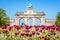 The arcade du Cinquantenaire on a sunny day  in Brussels, Belgium, with flowers in the foreground