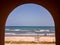 An arch at the ancient Danish fort of Fort Dansborg with a view of the sea in the