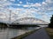 Arch bridge over the Albert canal and towpath on a cloudy day