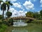 The arch bridge on the pond in the park and the nature scape.