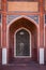 Arch with carved marble window. Mughal style