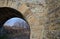 Arch of a classic railway bridge over a stream. sandstone blocks pressed into the vault as needed. renovation consists of penetrat