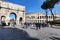 Arch of Constantine and the Colosseum from dei Fori Imperiali street with many tourist in beautiful winter day