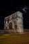 arch of constantine of the roman forum viewed through the gated arch of the passage at the entrance of the Roman Colosseum at