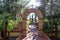 Arch With Cross Leading To Fountain In Monastery Garden