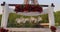 Arch with flowers in front of the Eiffel Tower in Paris. Establishing shot man making surprise proposal of marriage to