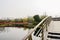 Arch footbridge with steel handrail over water