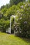 Arch in the green garden with blooming lilac