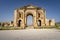 Arch of Hadrian at the roman ruins of Jerash, Jordan. Front view on a sunny day with blue sky. It features some unconventional,