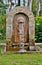 An arch made of stone with a lion head from which water flows