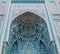 The arch of the mosque in blue tones is made from the mosaic of the Islamic religion.