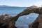 arch of portitxol on the costa brava with a tourist swimming a sunny summer day