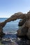 Arch of portitxol on the costa brava with a tourist swimming a sunny summer day