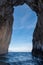 Arch in sea stacks off coast of Capri, Italy. They are named Stella, Faraglione di Mezzo with the arch, and Fraglione di Furori.