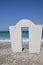 An arch standing on the pebble coast of the Aegean Sea in the village of Theologos in Rhodes, Greece