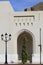 Arch, tree, lamp and watchtower at the Colonnade in Old Muscat