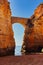 An arch between two rocks at Praia dos Estudiantes in Lagos, Portugal