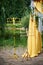 Arch for wedding ceremony in the open air, decorated with yellow fabric and flowers. Details close