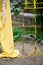 Arch for wedding ceremony in the open air, decorated with yellow fabric and flowers. Details close