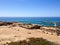 Archaeological excavations of sand on the ocean shore with the horizon view