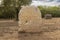 Archaeological remains of a sunlit stone Roman tombstone funerary mausoleum with inscriptions in the garden of the Los Columbarios