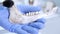 Archaeologist working in natural research lab. Laboratory assistant cleaning animal bones. Close-up of hands in gloves