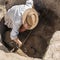 Archaeology - Archaeologist Digging Up Ancient Pottery