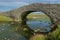 The arched Aberffraw Bridge in Anglesey