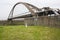 Arched Bridge Carrying Pipes Across Wide Canal