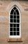 Arched church window set in sandstone bricks