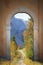 Arched door and mountainous autumn landscape