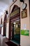 Arched doorway entrance with Koran Arabic Islamic prayer and minaret Hajjah Fatimah Mosque Singapore