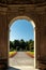 Arched doorway leading to a formal garden