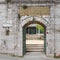 Arched entrance with green metal door leading to 17th century Cinili Mosque in Uskudar, Istanbul, Turkey