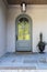 Arched front door with light and plant